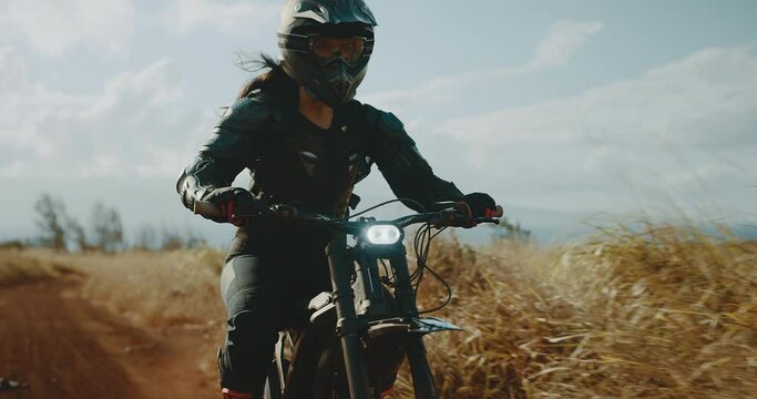 Woman riding electric dirt bike, adventure active outdoor lifestyle