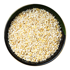 crushed pot barley groats in round bowl isolated