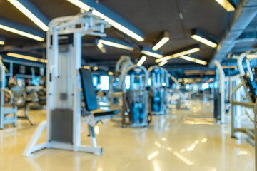 Fototapeta na wymiar Abstract blur of defocused modern gym interior and fitness health club with sports exercise equipment,fitness center interior background.