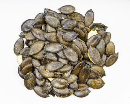pile of styrian pumpkin seeds close up on gray