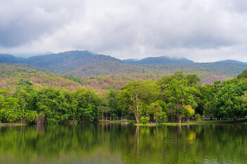Fototapeta na wymiar landscape lake views at Ang Kaew Chiang Mai University in nature forest Mountain views spring cloudy sky background with white cloud.