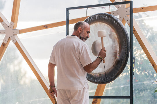 Spiritual man hitting gong