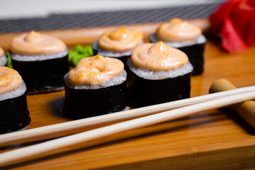 Philadelphia roll sushi with salmon, shrimps, avocado, cream cheese. Sushi menu. Japanese food..Sushi roll isolated on white close up