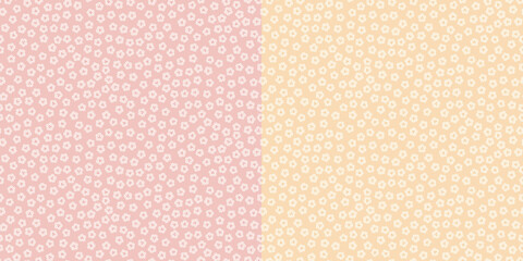 Seamless ditsy pattern of small flowers in pink and yellow variations.
