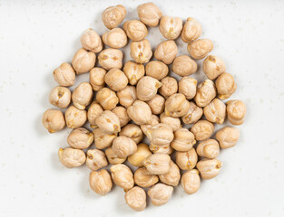 pile of raw dried chickpea seeds close up on gray
