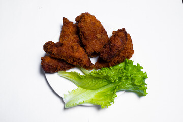 Baked chicken wings with sesame seeds with herbs and sweet sauce in a white box on the table
