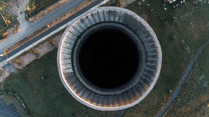Old metal factory chimney in Caen, Colombelles, Normandy, drone photo at sunset, industrial area