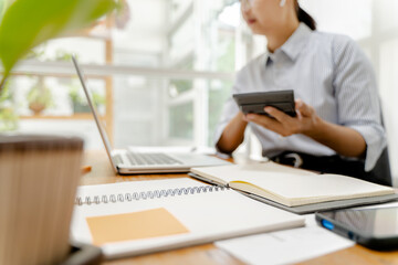 Young asian woman secretary working with laptop at contemporary office..