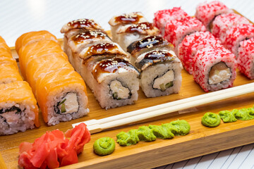 Philadelphia roll sushi with salmon, shrimps, avocado, cream cheese. Sushi menu. Japanese food..Sushi roll isolated on white close up