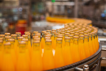 Beverage factory interior. Conveyor flowing with bottles for juice