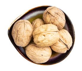 top view of whole walnuts in ceramic bowl isolated