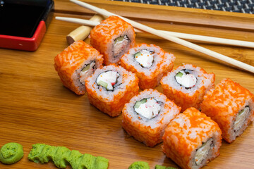 delicious sushi rolls on a wooden board