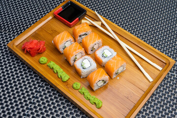 delicious sushi rolls on a wooden board