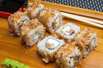 Philadelphia roll sushi with salmon, shrimps, avocado, cream cheese. Sushi menu. Japanese food..Sushi roll isolated on white close up