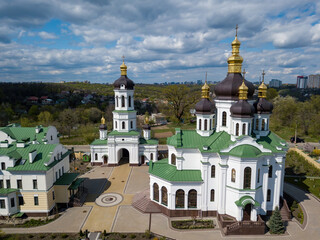 Fototapeta na wymiar Orthodox church on the outskirts of the forest. Aerial drone view.