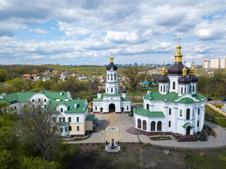 Fototapeta na wymiar Orthodox church on the outskirts of the forest. Aerial drone view.