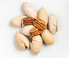pile of cracked and shelled pecan nuts close up
