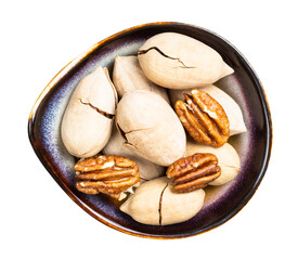 cracked and shelled pecan nuts in bowl isolated