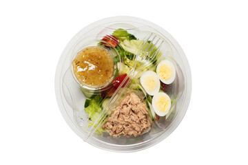 Fresh tuna salad with lettuce, cucombers, cherries and eggs in plastic container.