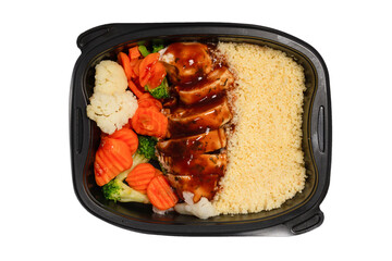 Ready food in a container. Stewed chicken in teriyaki sauce, stewed carrot, cabbage and porridge.