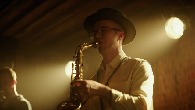 HANHDHELD CU Portrait of jazz band playing saxophone on stage during a live concert in small venue. Shot on ARRI Alexa Mini LF with 2x anamorphic lens