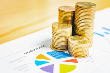 Saving money as a concept. Vintage retro stack of gold coins on the wooden background to represent It's time to do investing for retirement planning.