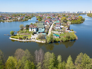 Fototapeta premium River in a suburban village. Aerial drone view.