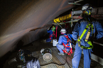 Male  worker inspection  tank of rust thickness in to confined