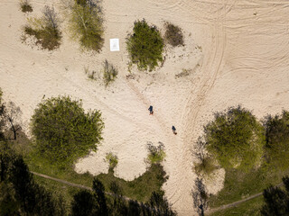 Sandy shore of the lake on the outskirts of the city. Aerial drone view.