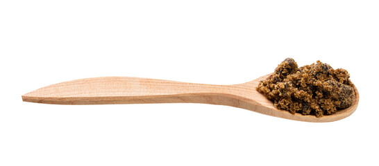 muscovado cane sugar in wooden spoon isolated