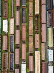 Freight trains on railway tracks. Aerial drone top view. Sunny spring day.