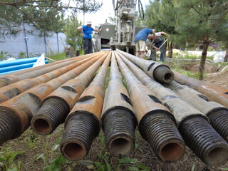 Europe, Kiev region, Ukraine - June 2021: An engineer is drilling a water well. Drilling rig worker during work. The process of drilling a well for water. Drilling rig.