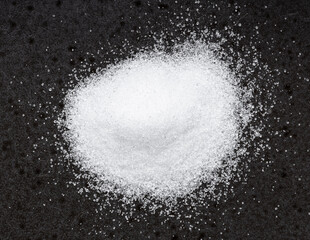 pile of crystalline erythritol sugar on black