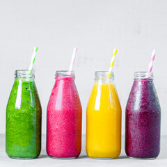 Colorful smoothie in glass bottles. Summer fruit smoothies in jars. Healthy, detox and diet food concept.