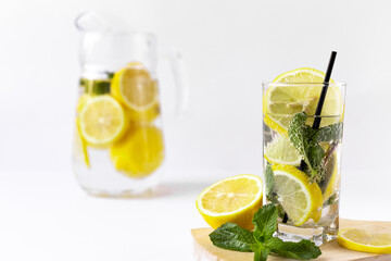 fresh cocktail with lemon and jug in the background