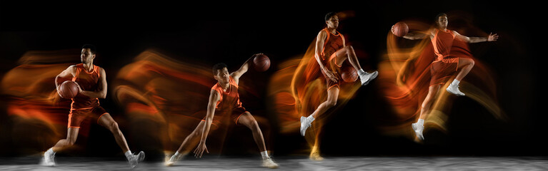 Sportsmen playing basketball on black background in mixed light. Caucasian fit young male players...