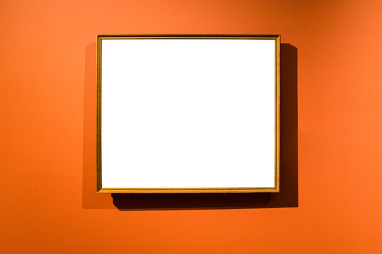 narrow wooden picture frame on orange wall
