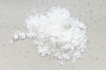 Fototapeta na wymiar top view of pile of baking powder close up on gray