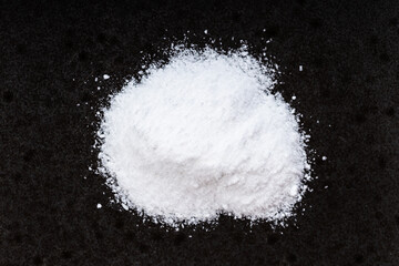 Obraz na płótnie Canvas pile of vanillin powder close up on black