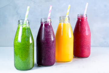 Colorful smoothie in glass bottles. Summer fruit smoothies in jars. Healthy, detox and diet food concept.