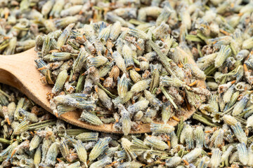 spoon with old dried lavender close up on pile