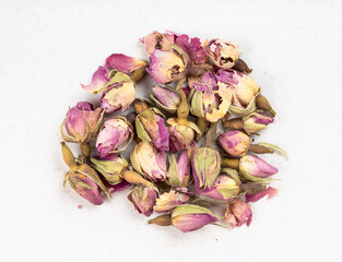 pile of old dried rosebuds close up on gray