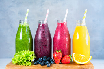 Colorful smoothie in glass bottles. Summer fruit smoothies in jars with ingredients. Healthy, detox and diet food concept.