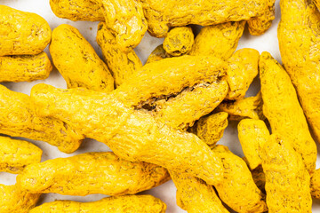 background - many whole Turmeric (Curcuma) roots