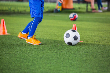 Children playing control soccer ball tactics on grass field with for training