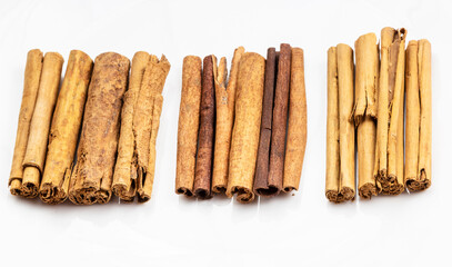 different cinnamon sticks on white plate