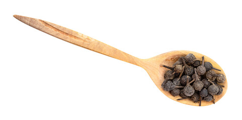 top view of tailed pepper (cubeb) in wood spoon