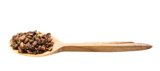 pink sichuan pepper in wooden spoon isolated