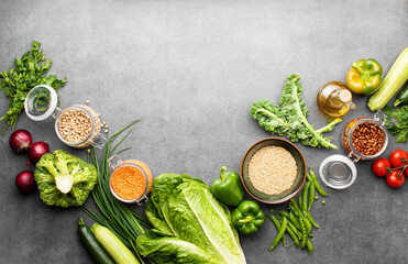 Fototapeta na wymiar Green vegetables and beans, top down view vegan culinary background