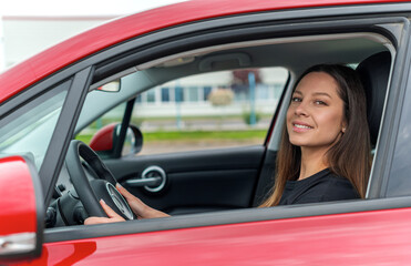 Beautiful young woman driving a car. Attractive brunette in the car.